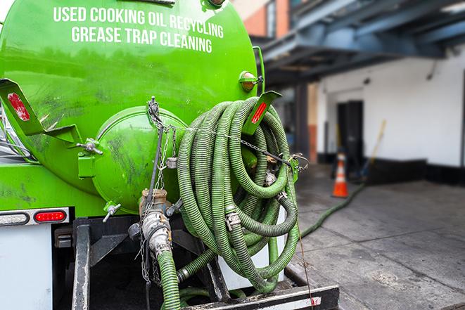 grease trap pumping truck in action in Bolingbrook